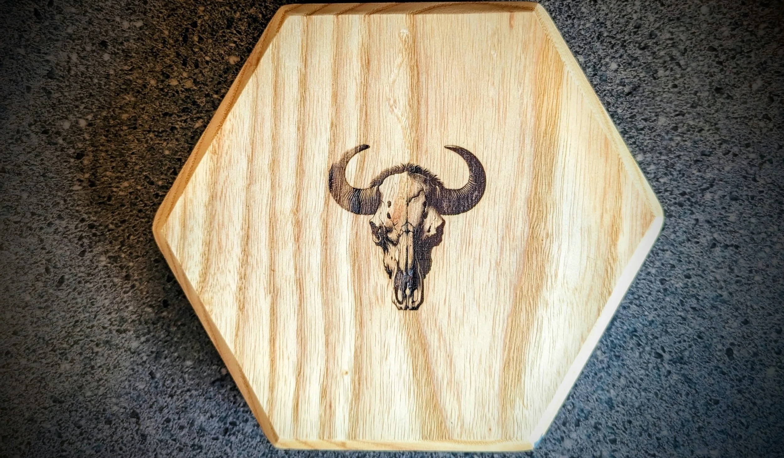 Hexagonal ash coaster with laser-engraved bison skull