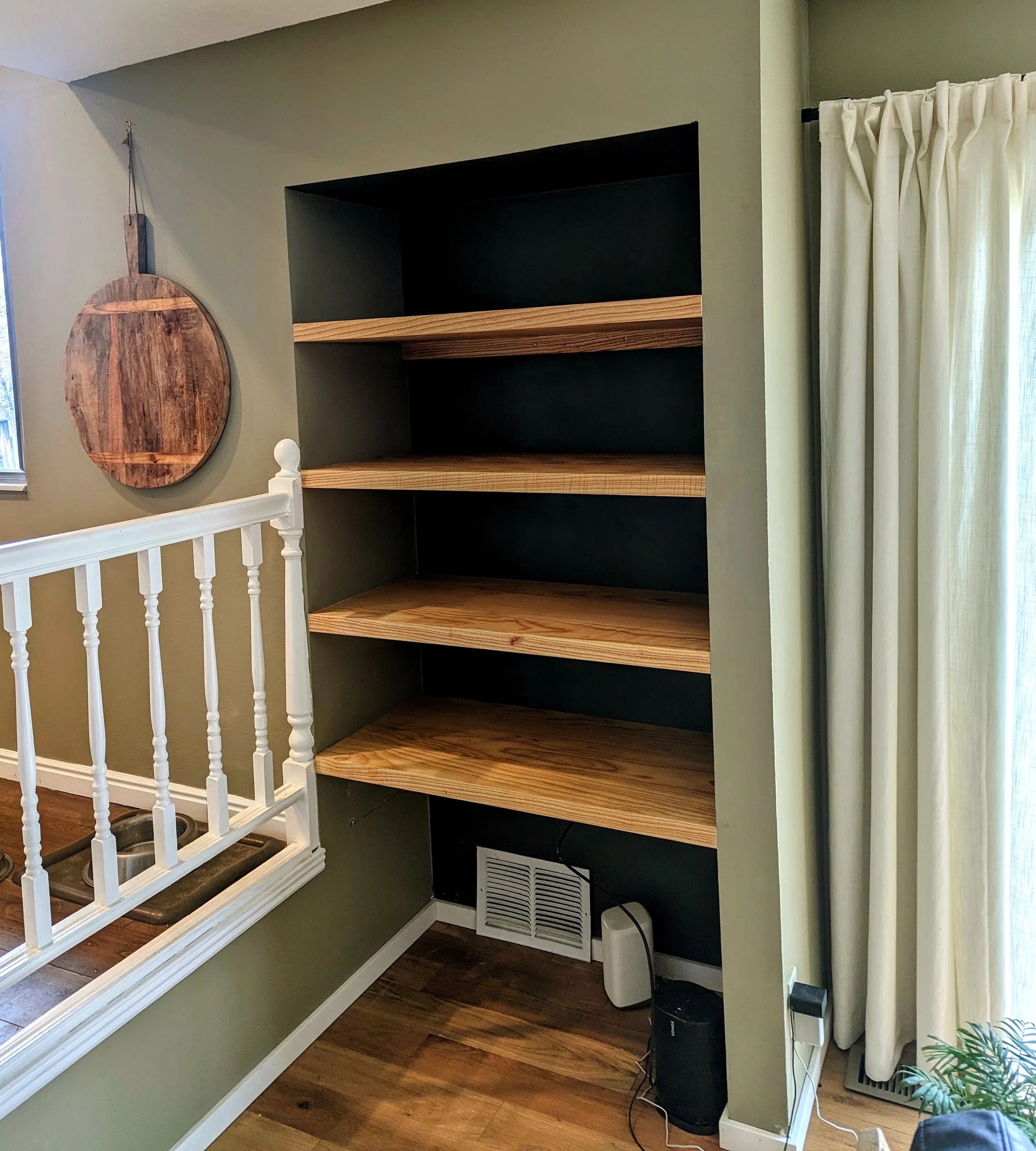Empty shelves showing the beautiful ash grain and flush wall fit
