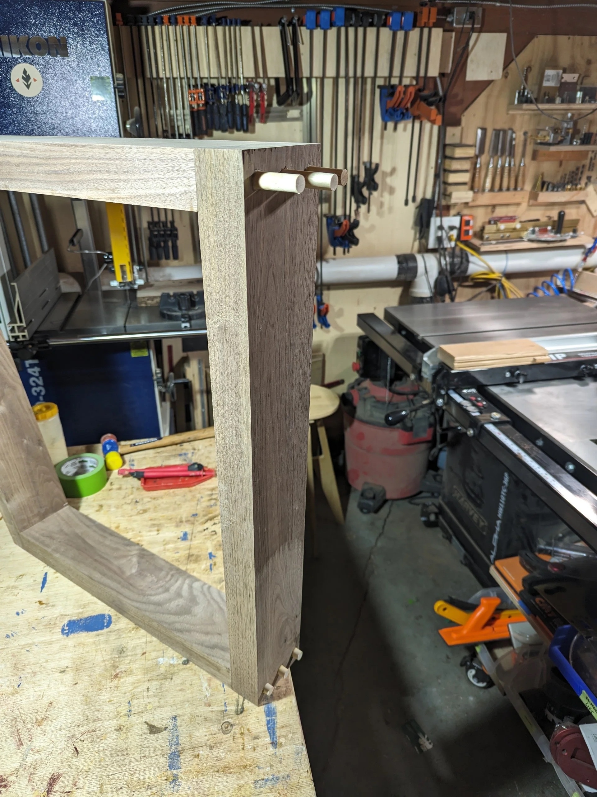 Leg frame with birch dowel inserted — the floating joint