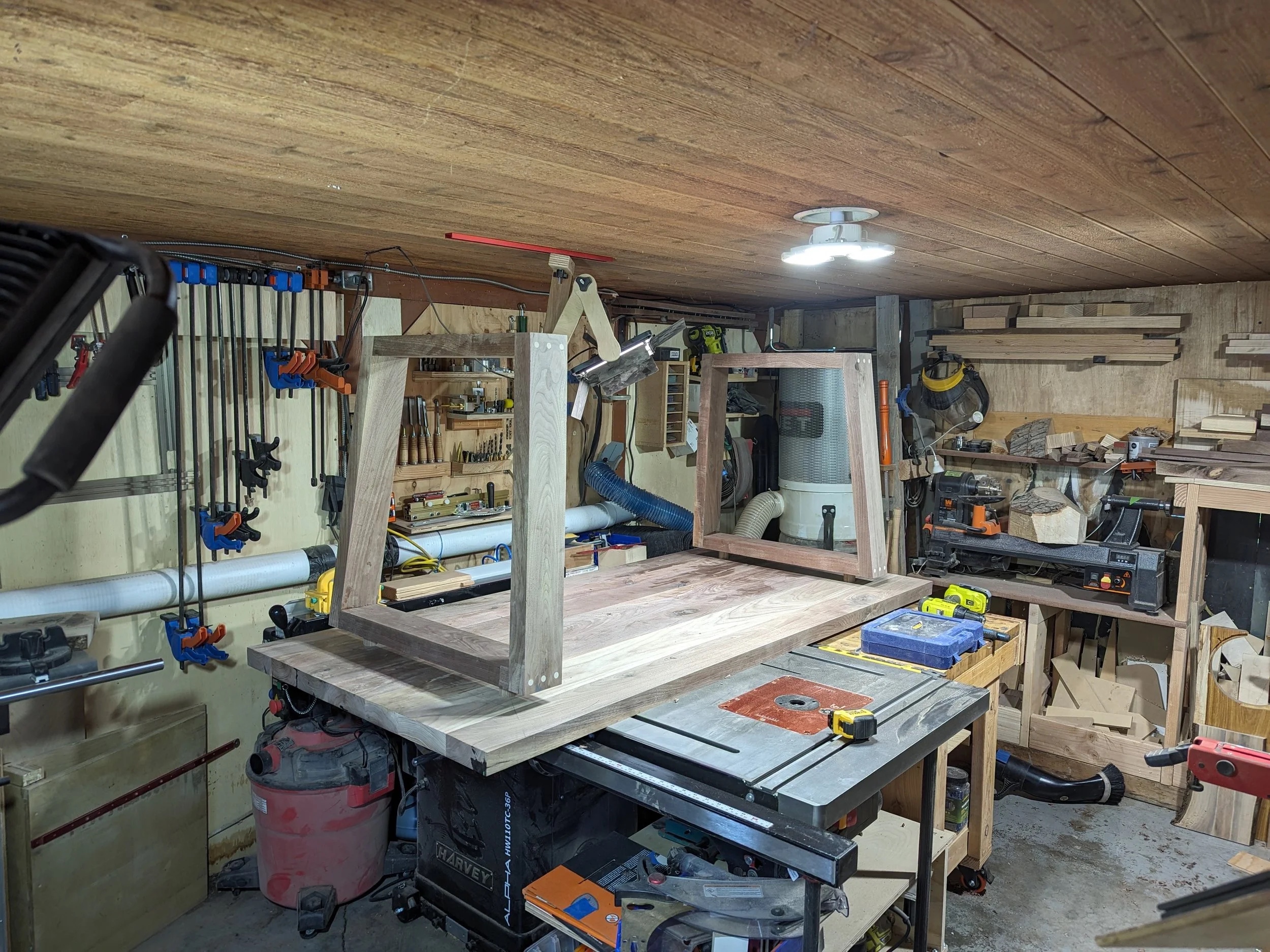 Table frame upside down on workbench — early construction
