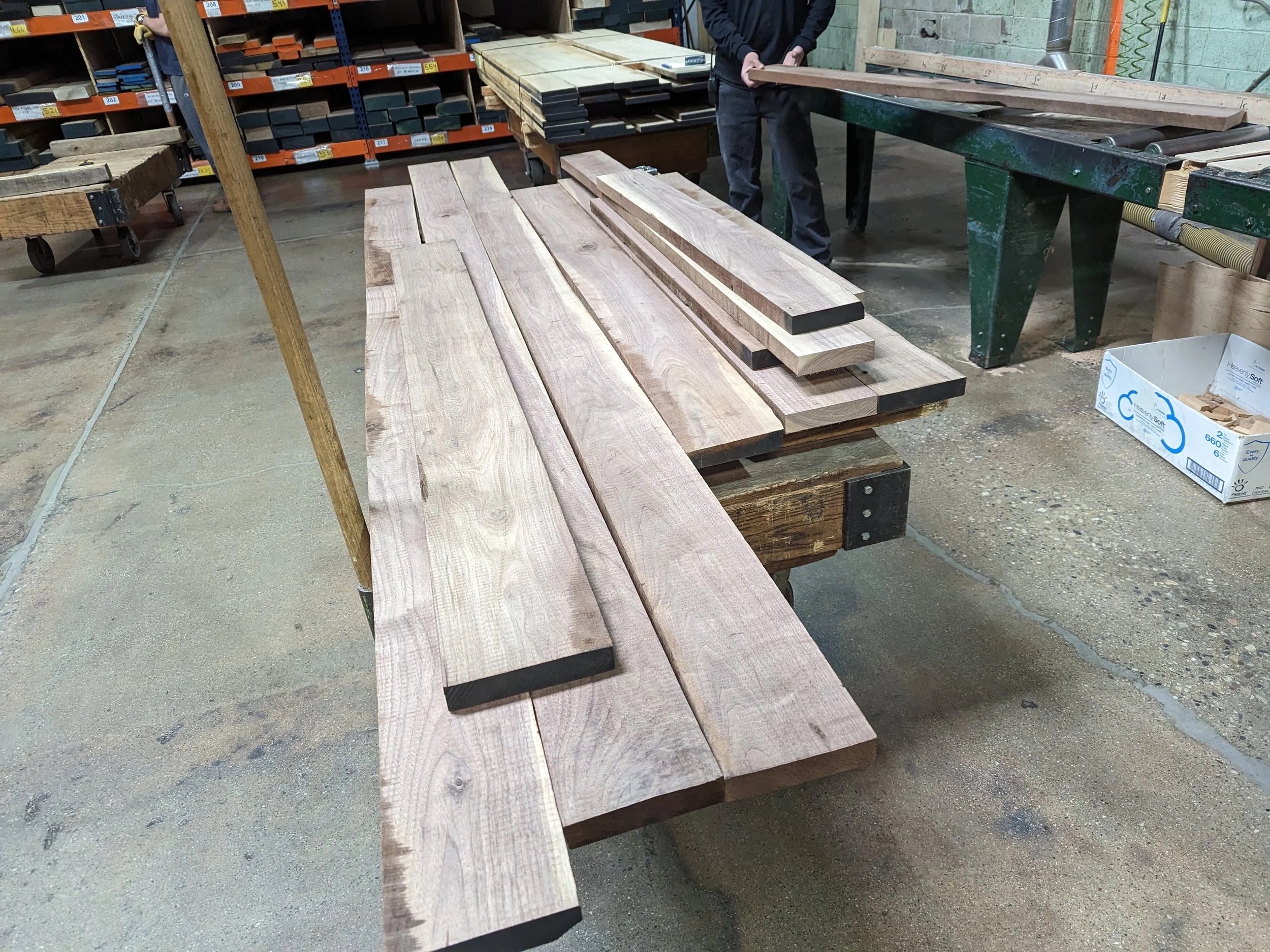 Raw walnut boards at the lumber yard, hand-selected for grain and character