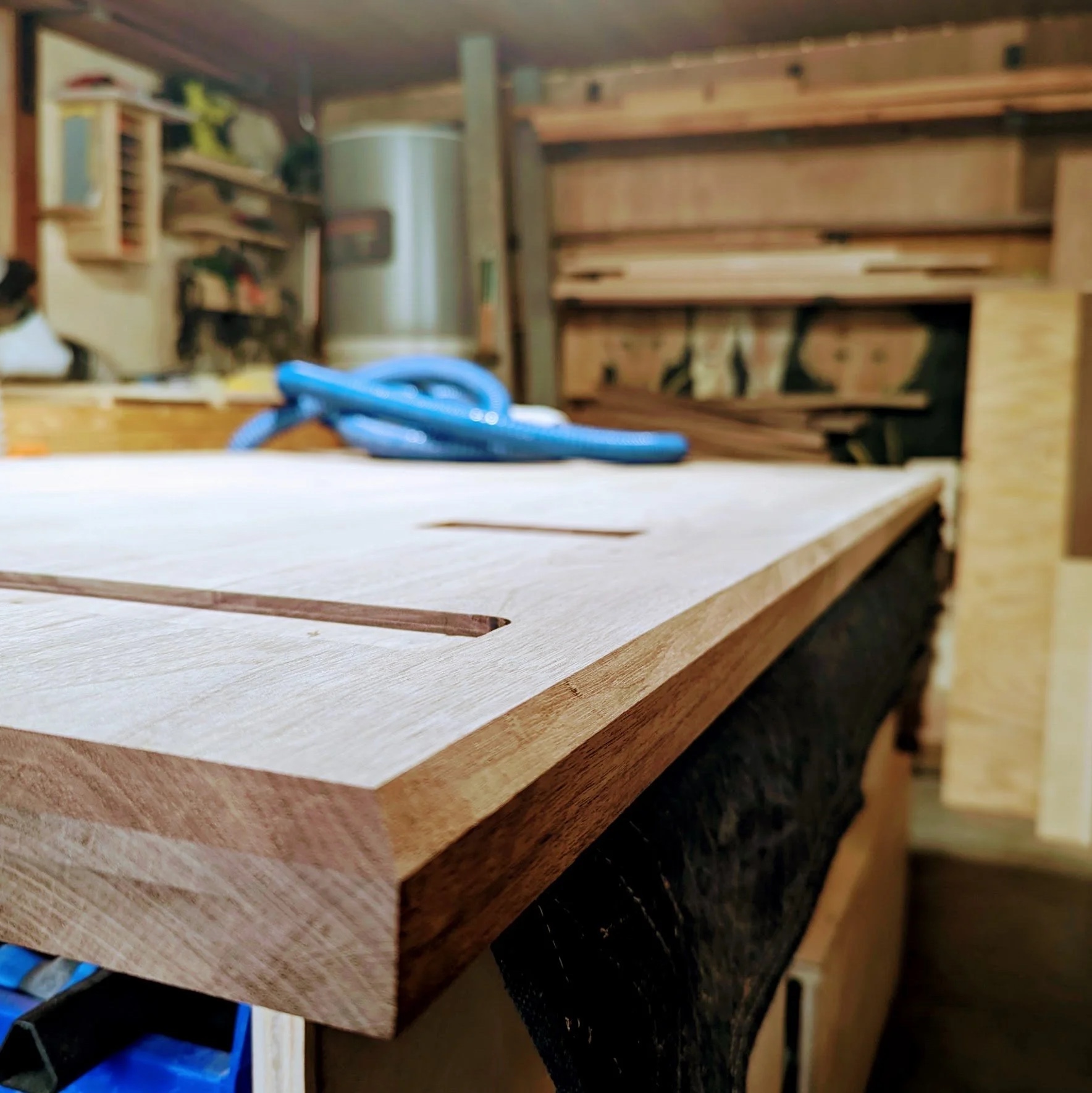 Close-up of the routed recess and leg attachment plates on the underside