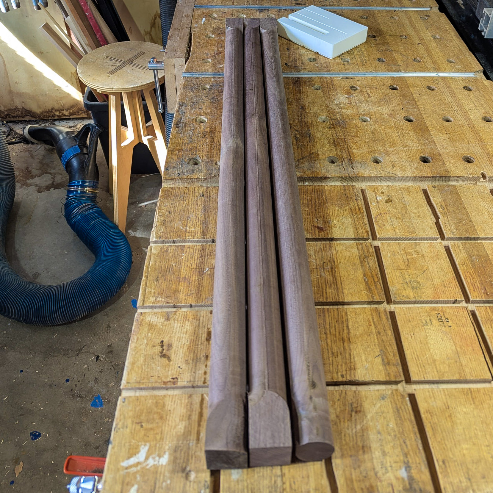 Three walnut dowels in transition from rectangular to round