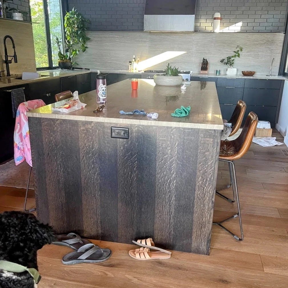Modern kitchen with quarter-sawn white oak cabinetry, wide floorboards, and Jefe the dog