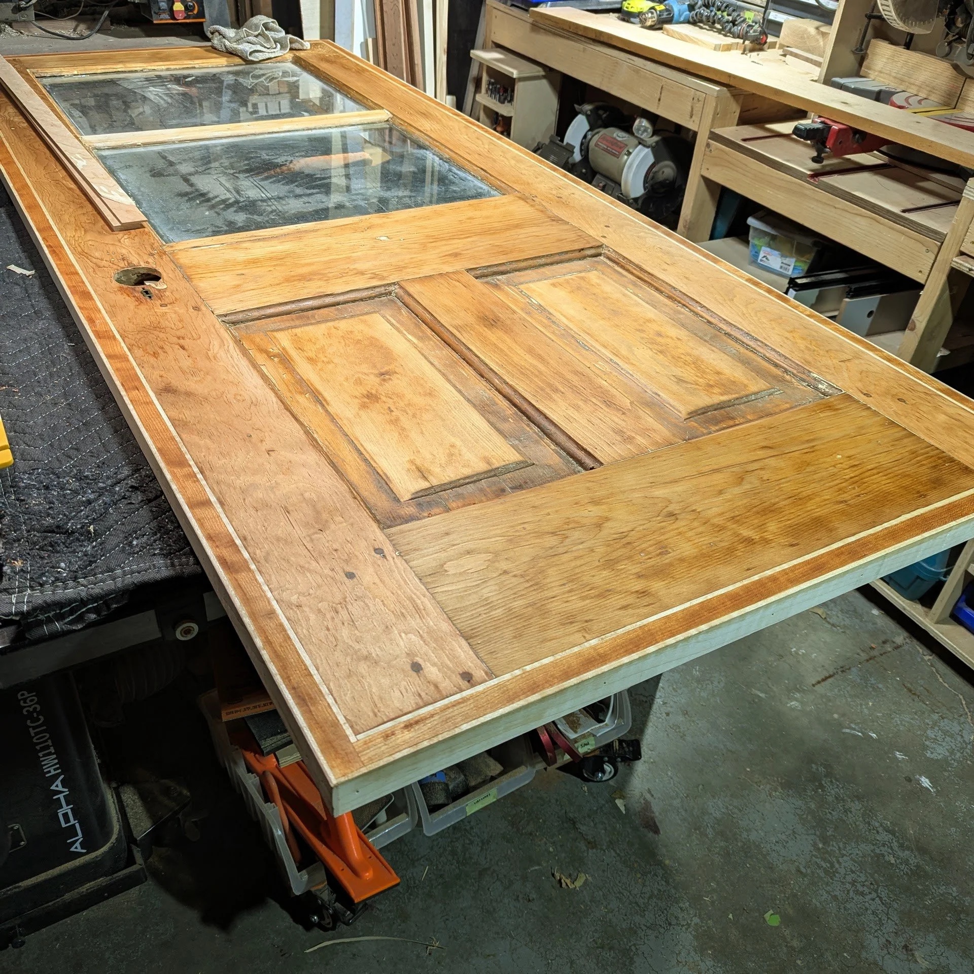 Stripped pine door framed in maple — ready for installation