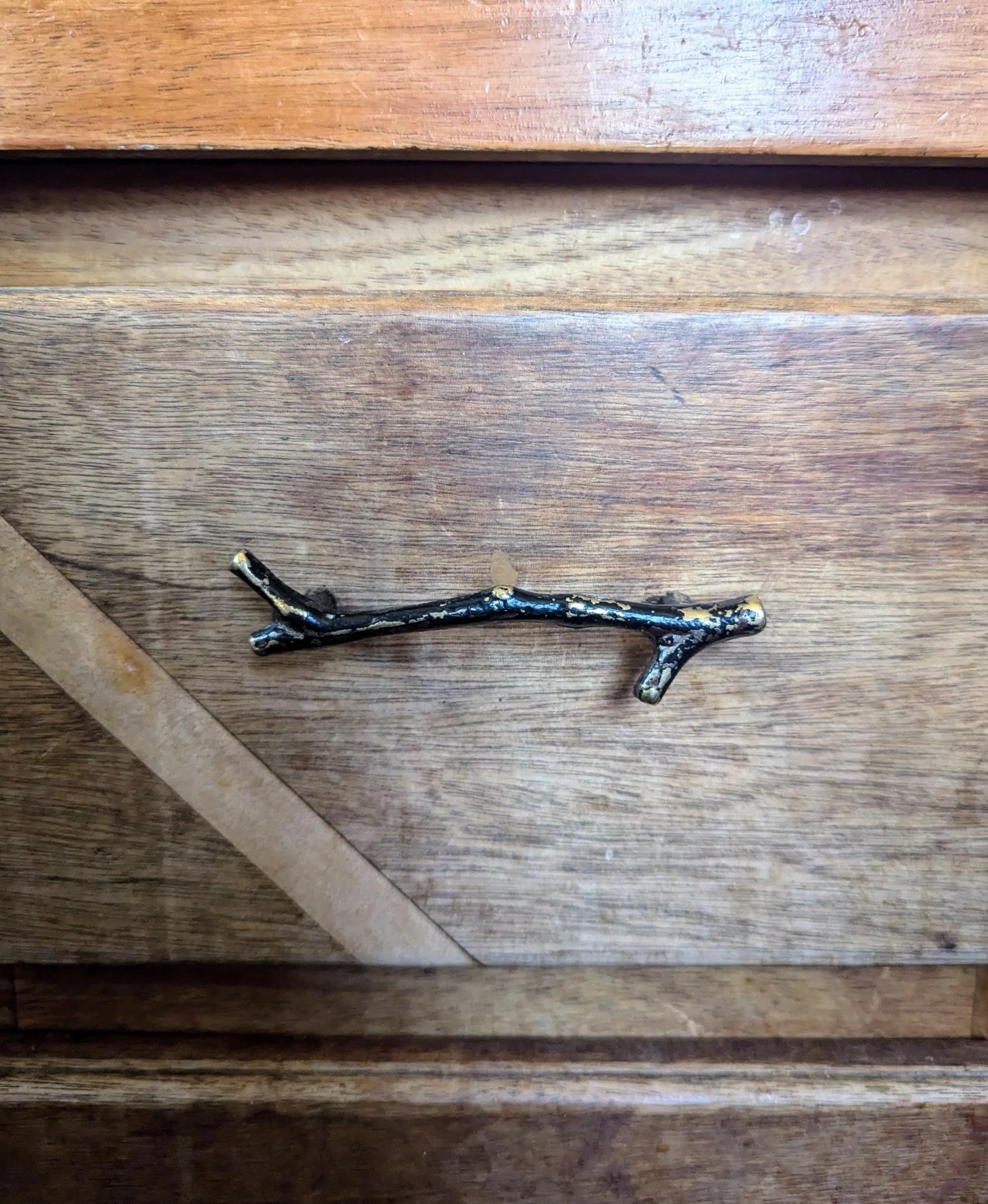 Cast iron branch handle on pine door panel