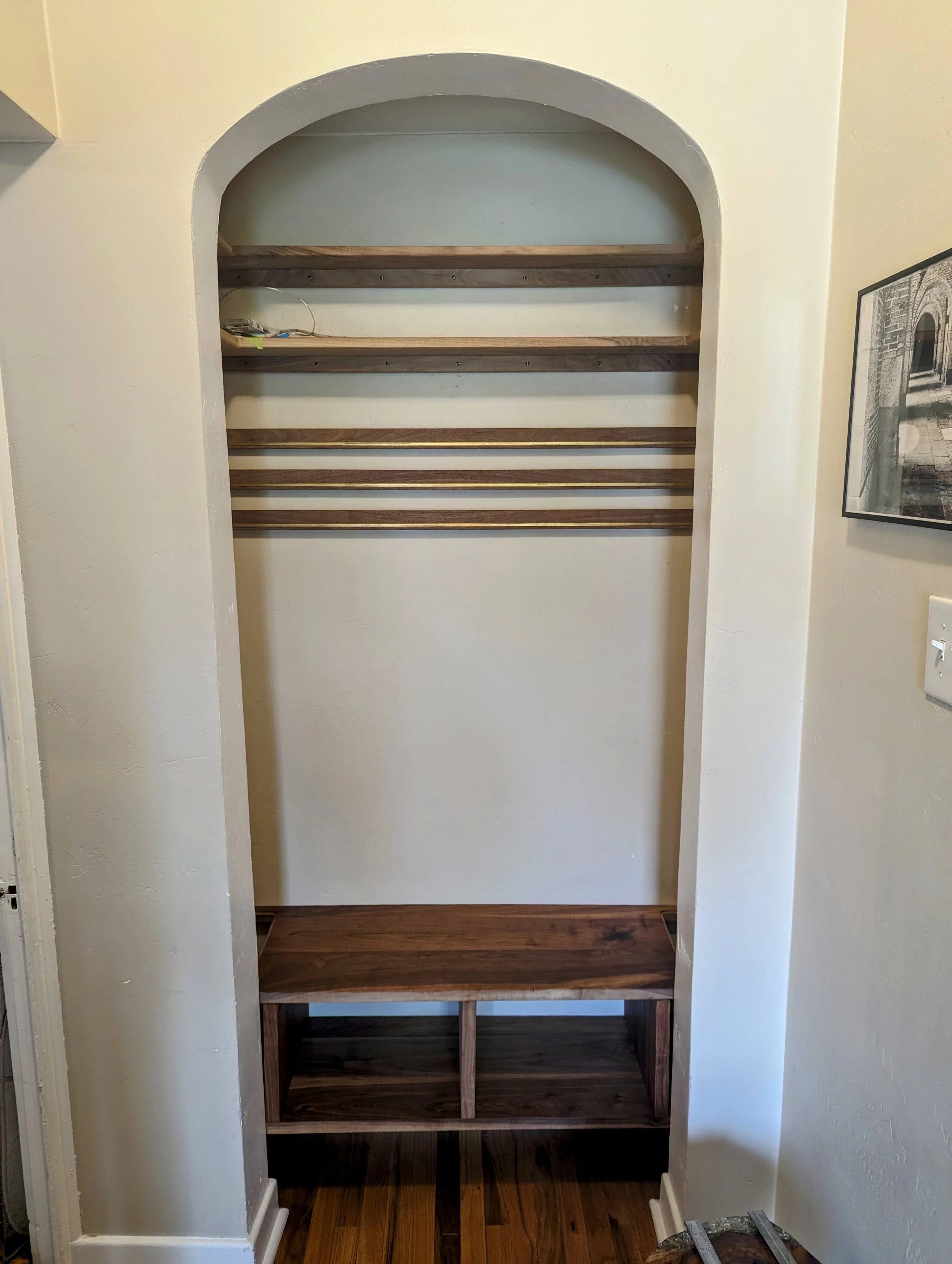 Structure installed — shelves, cleats, and bench frame in the arched nook