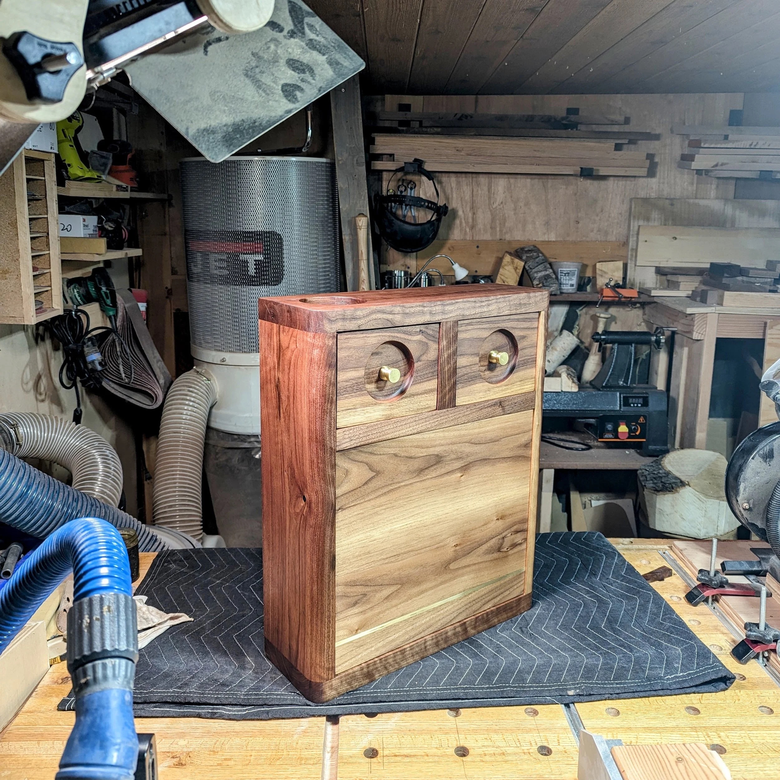 The Owl cabinet — standalone walnut cabinet with brass drawer pulls, built in the workshop