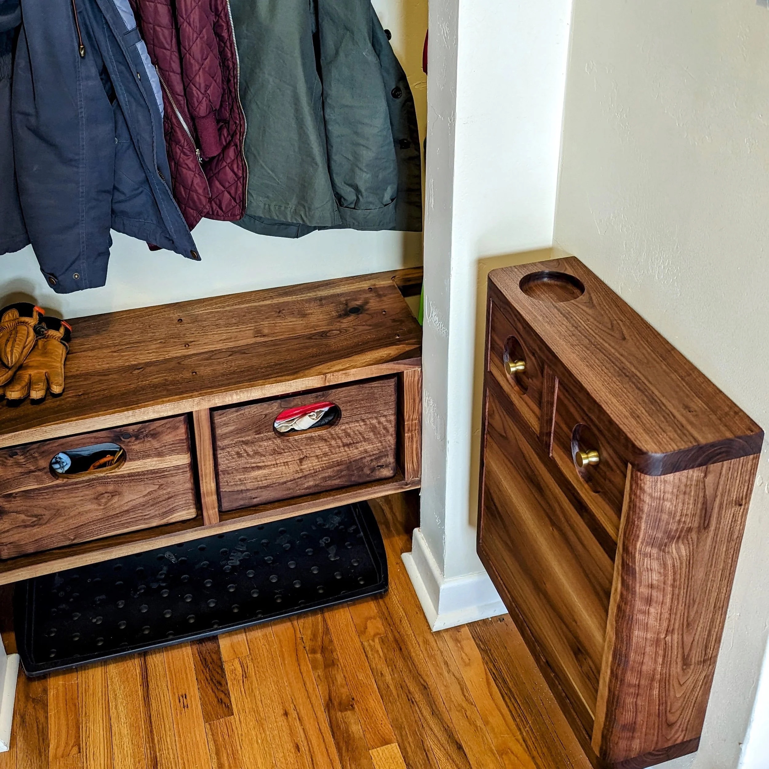 El Guardarropas from the side — walnut crates with shoes, the Owl cabinet beside the nook