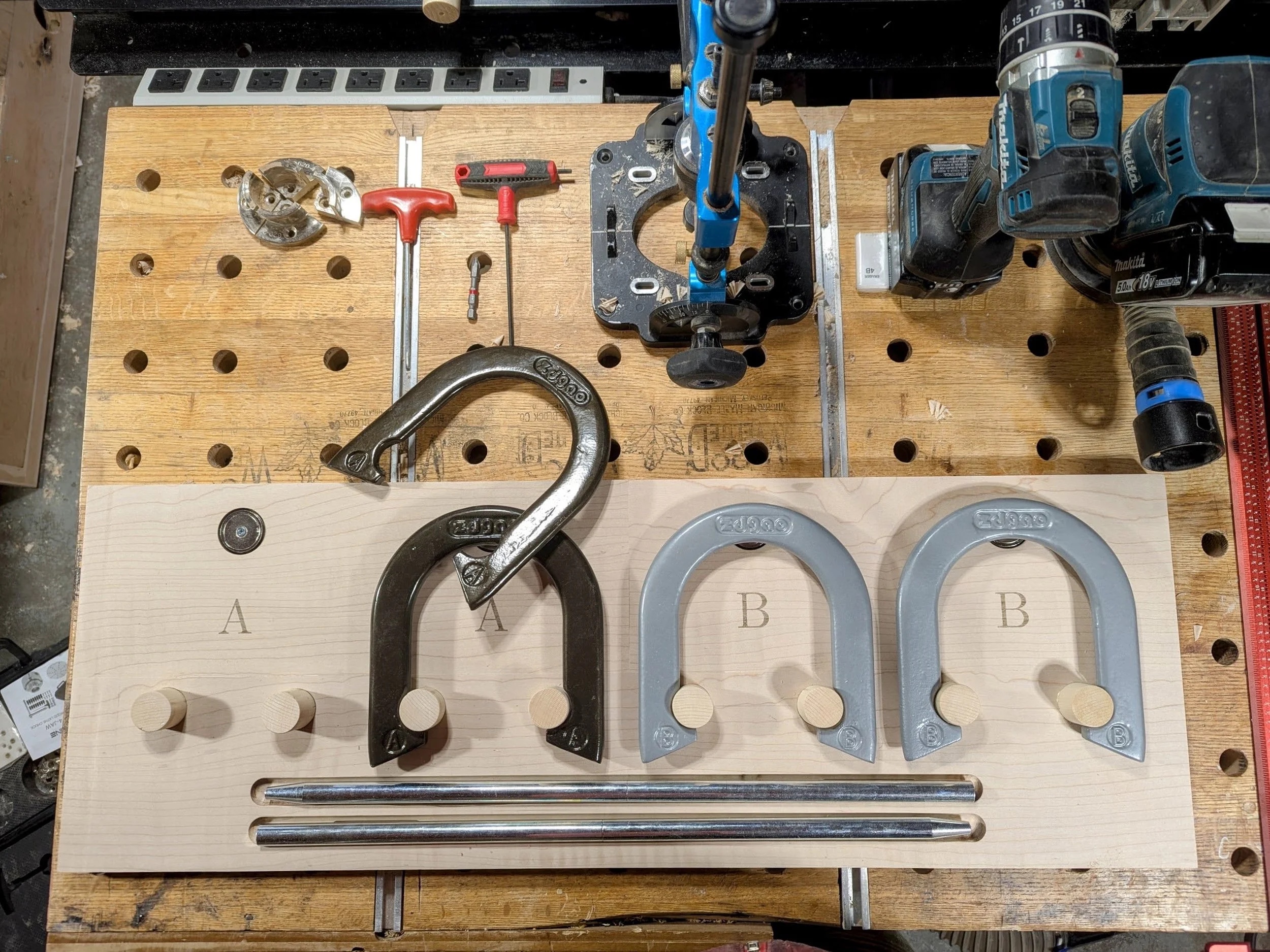 Workshop — horseshoes, pegs, and stakes laid out on workbench