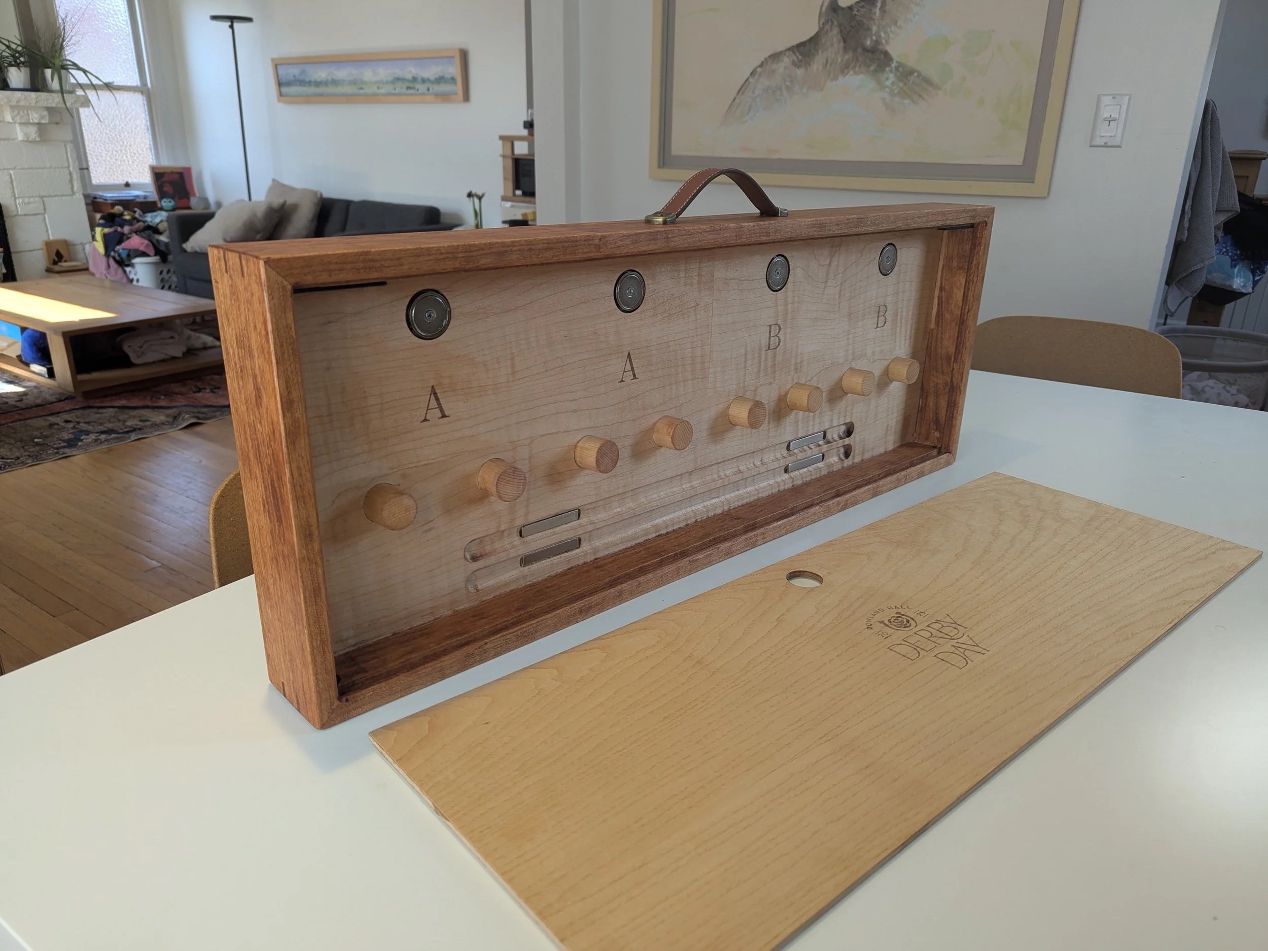 La Herradura open — cherry frame with maple interior, horseshoes on dowels