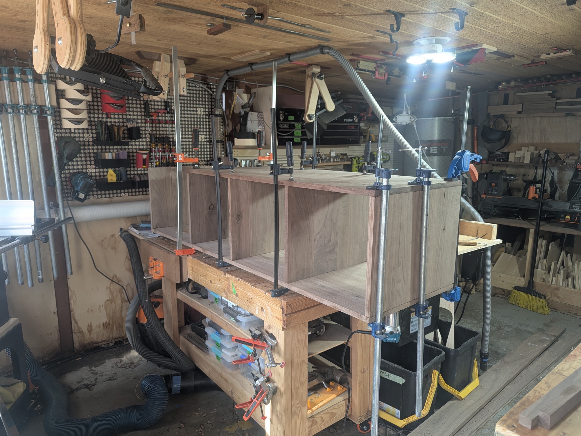 Carcass clamped during divider glue-up with bar clamps and pipe clamps