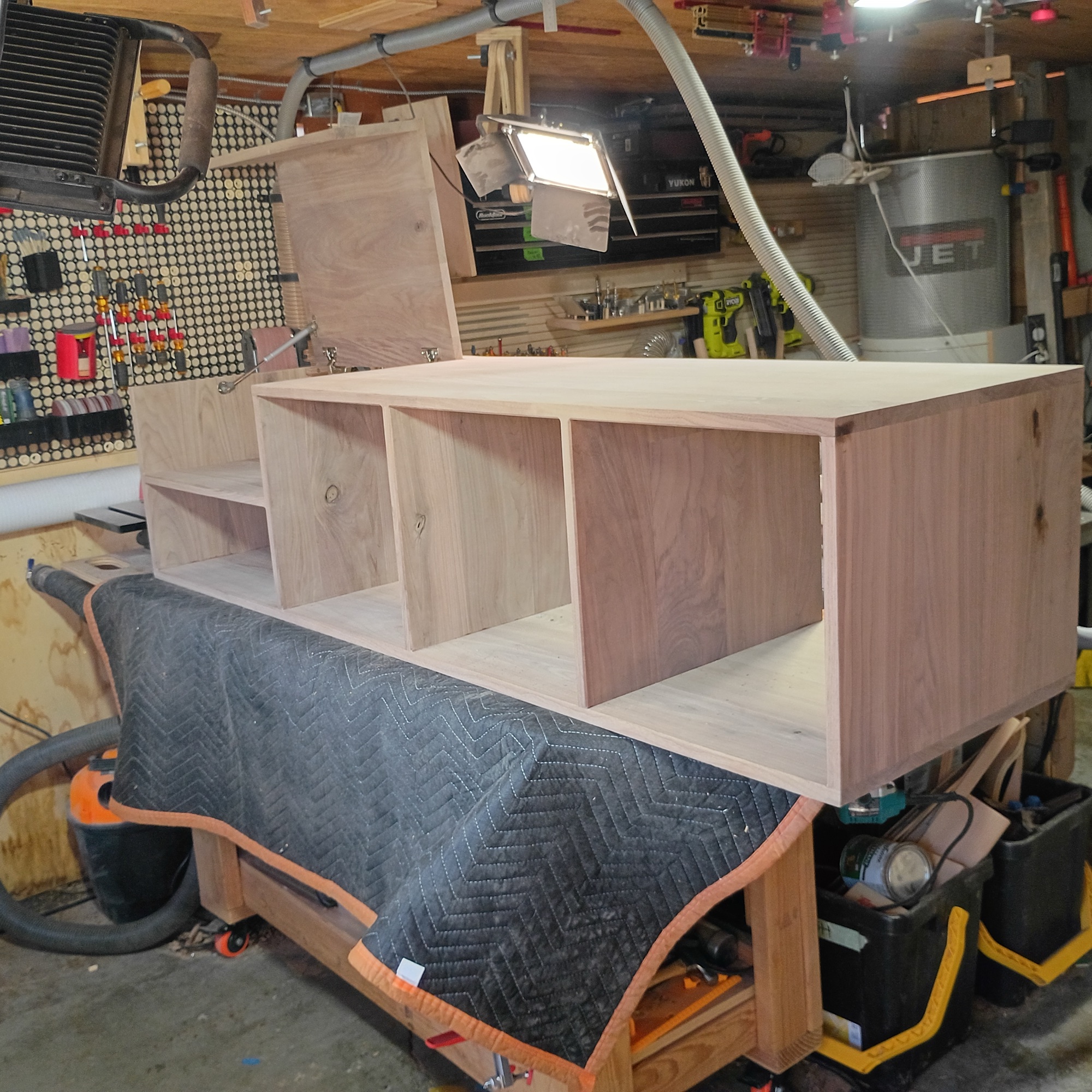 Completed carcass — four bays visible: turntable compartment, electronics bay, and three record drawer openings