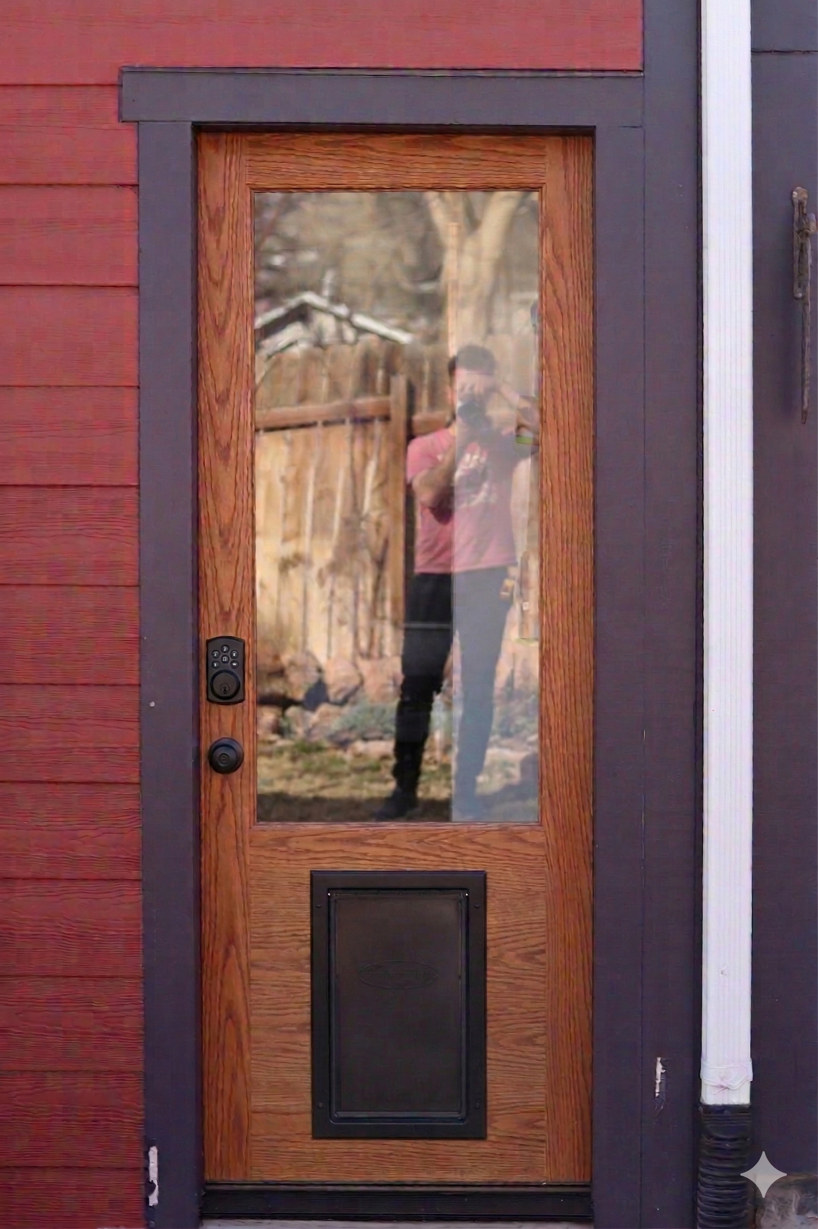 Design concept in context — the new oak door rendered against the existing exterior, showing proportions and black hardware