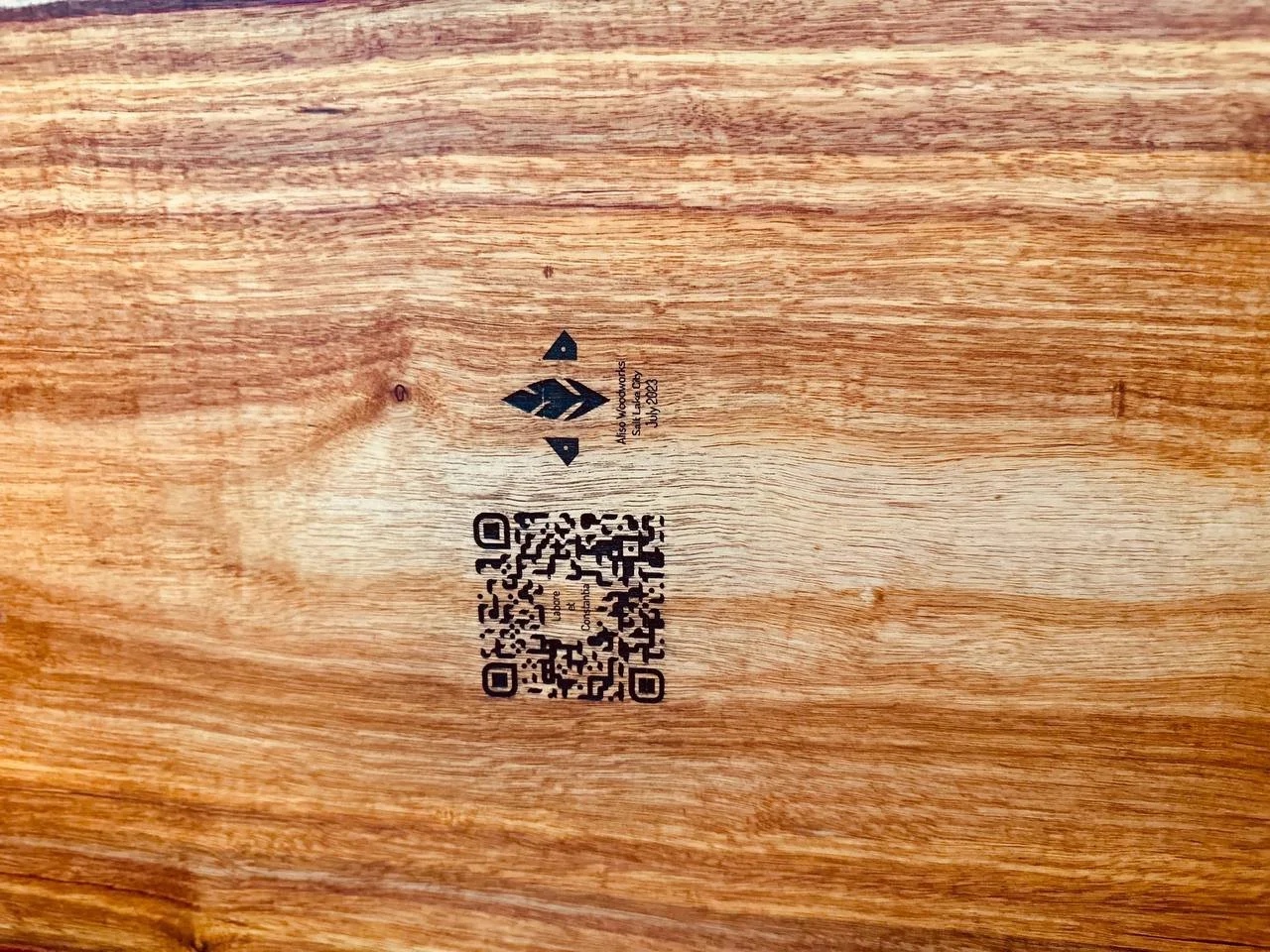 Maker's mark and QR code laser-engraved on the underside