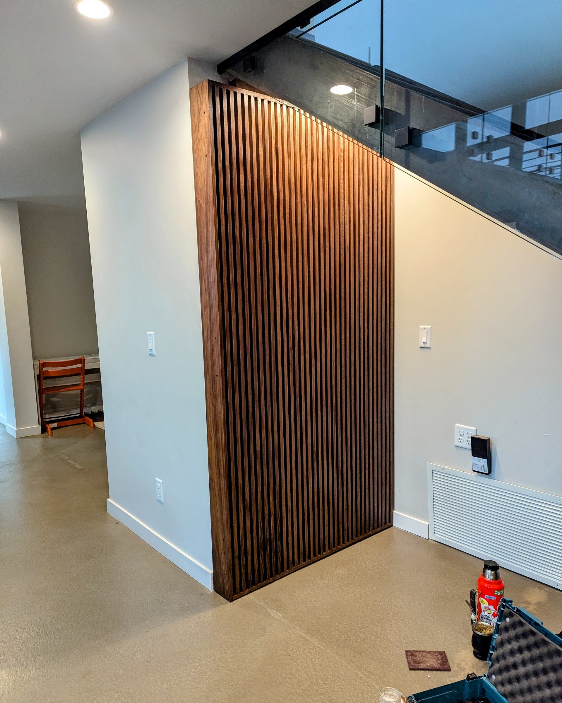 The Nook — slatted walnut door closed, full height against the staircase