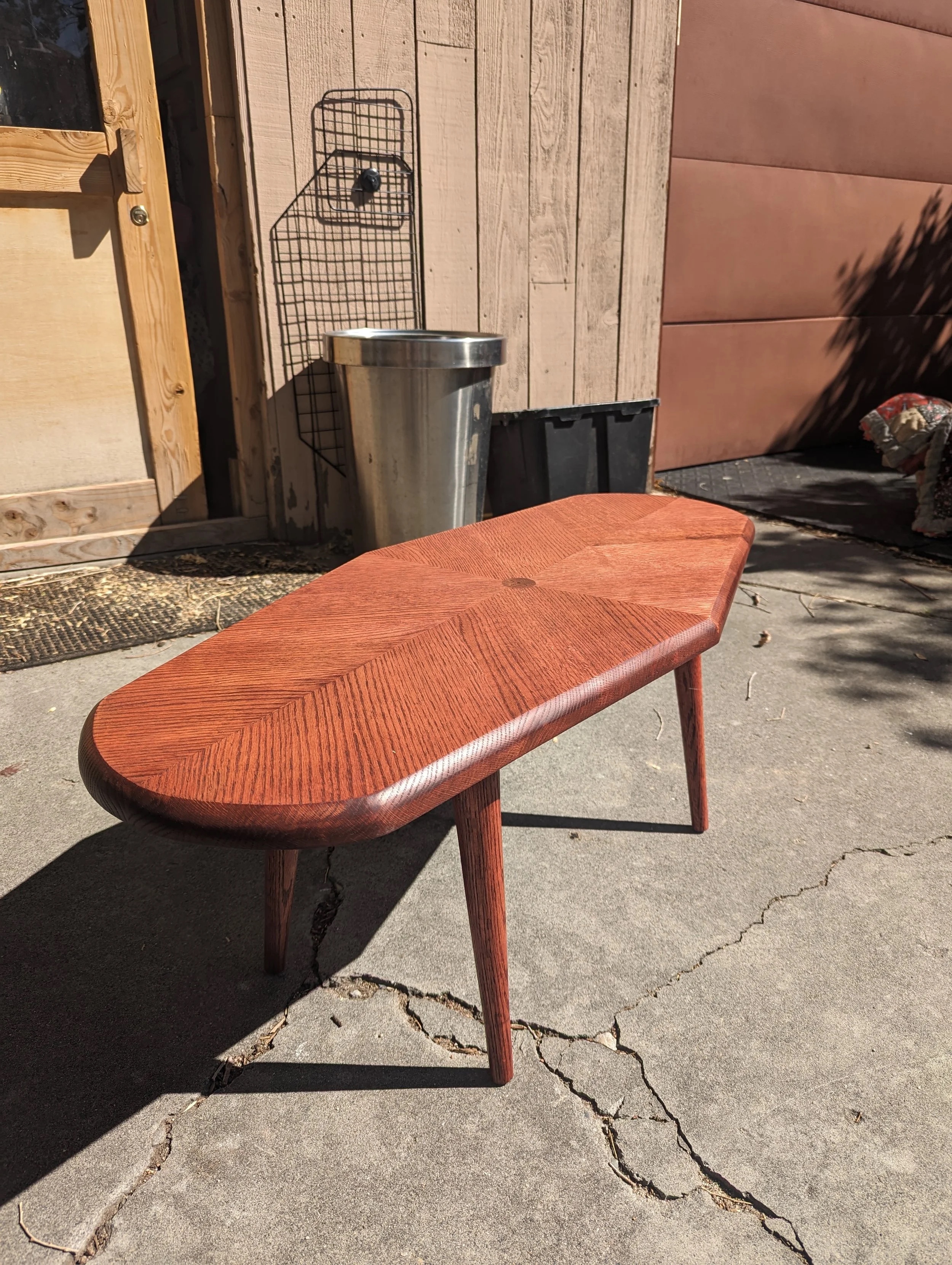 The Red Tiger in natural light — cherry-stained red oak with chevron pattern