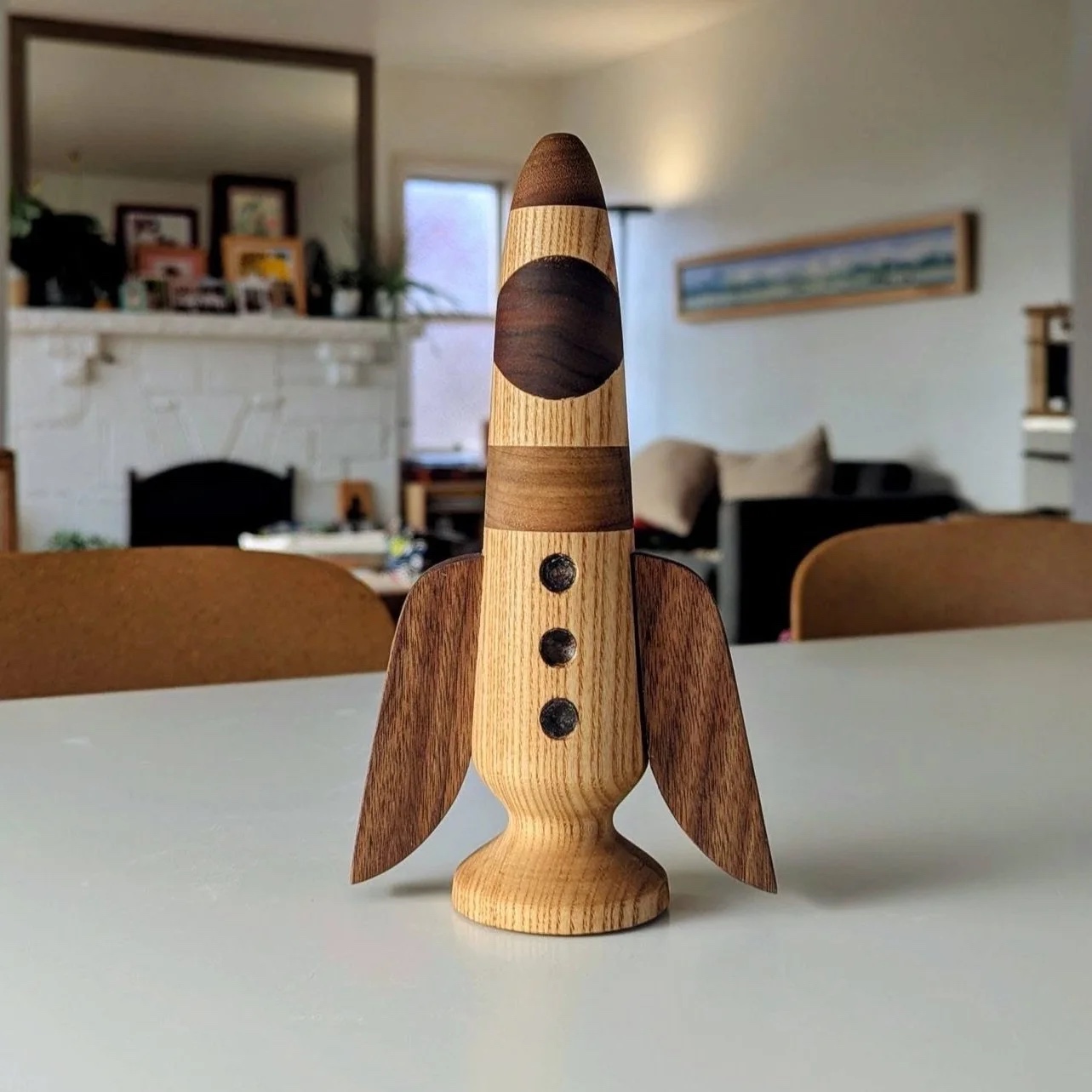 The Rocket — finished ash and walnut wooden rocket with walnut window and swept fins