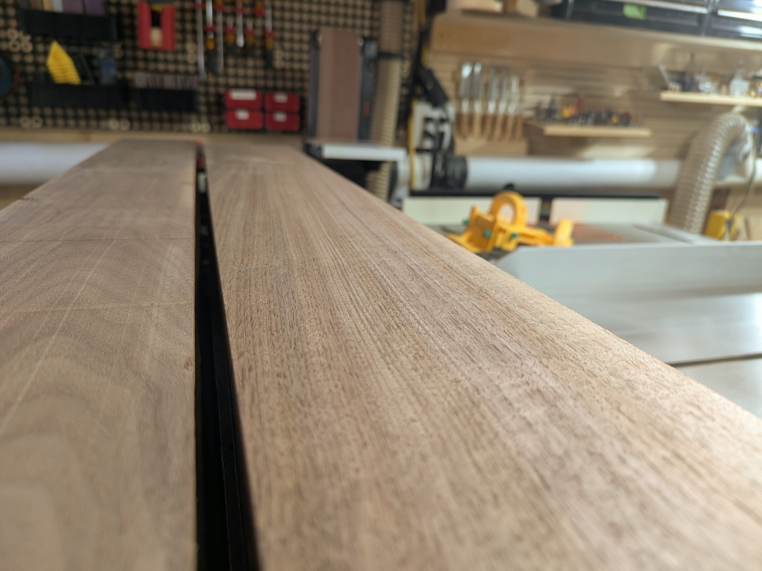 Milled walnut stacked and waiting — every piece paired and labeled for its role in the build