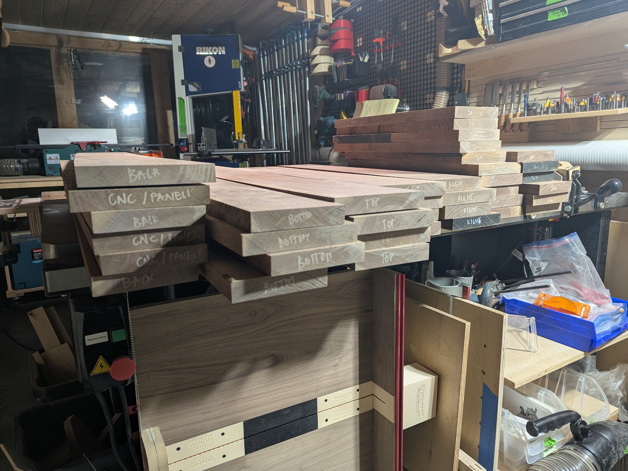 Every board labeled with tape and marker — board number plus assignment, so no piece gets miscast