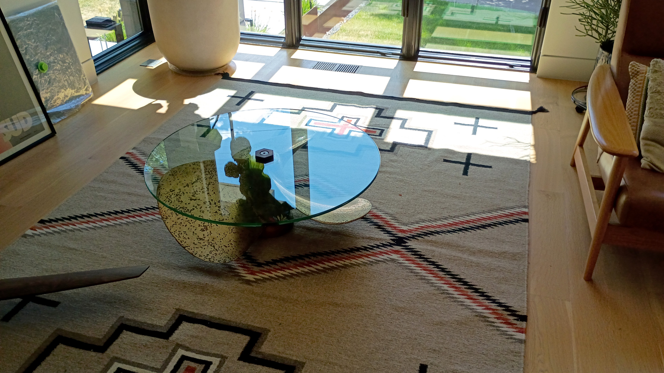 La Propela in Ali and Eduardo's new house — bronze propeller base under a round glass top, afternoon light