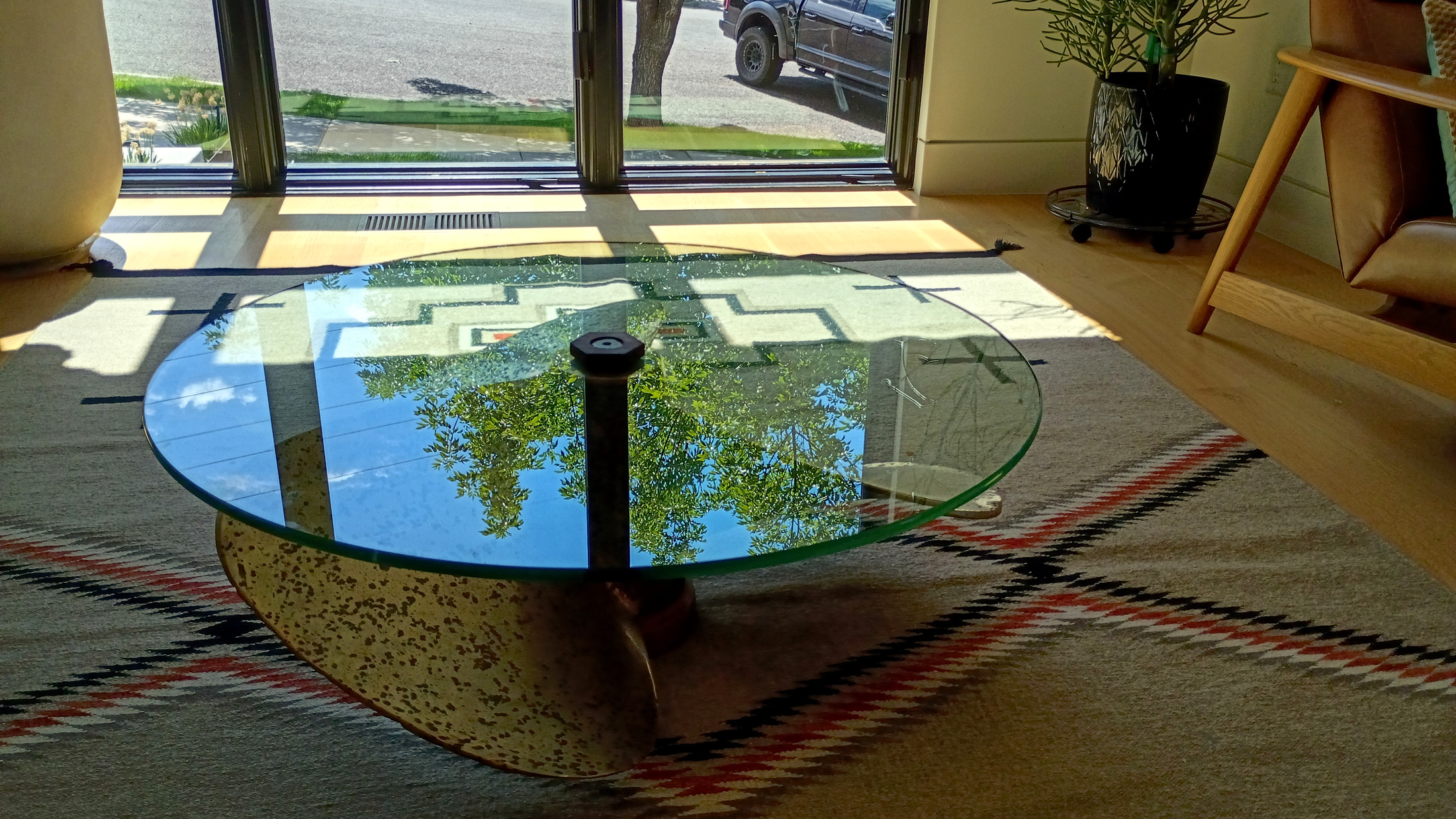 Side profile — glass top, propeller base, and the new hexagonal nut crowning the center