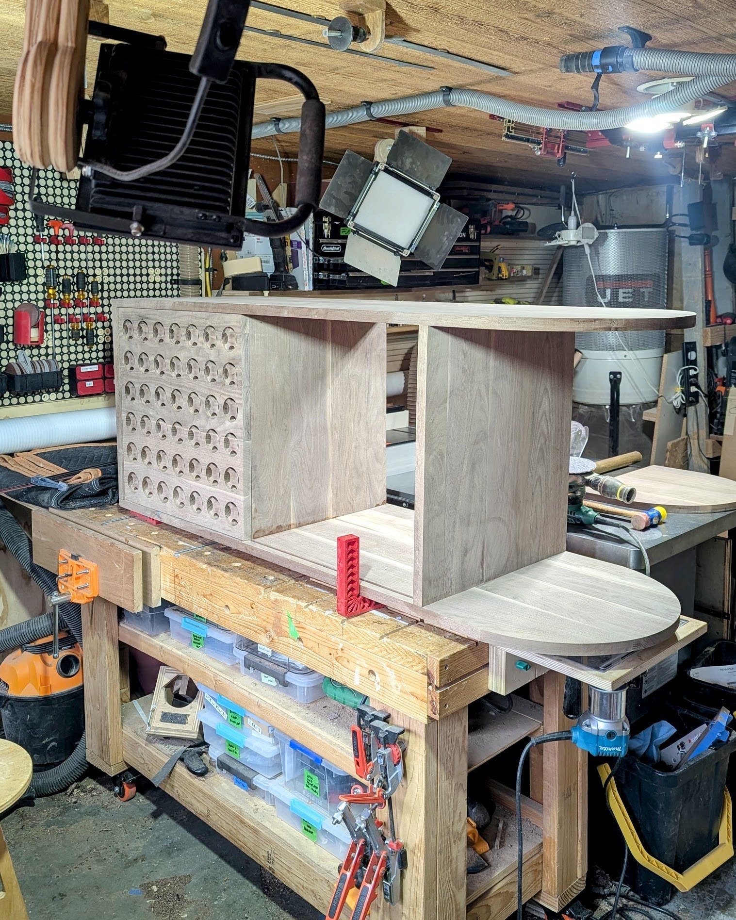 First full assembly on the workbench: the speaker-grille door, open shelving and rounded end together for the first time