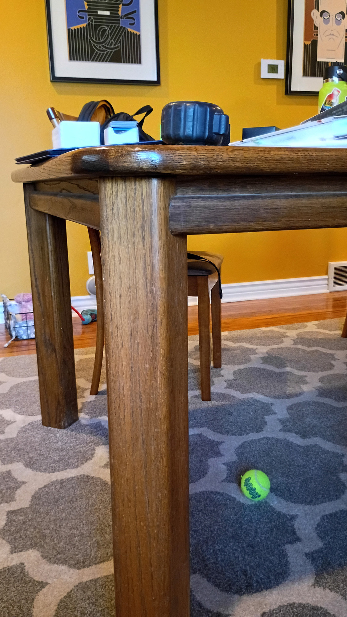 Close-up of the heirloom table's corner and leg, decades of use in the oak